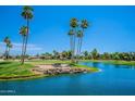 Golf course view with a lake and palm trees at 12208 N 103Rd Ave, Sun City, AZ 85351