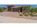 Modern home exterior with a large garage and landscaping at 2054 E Entoro Dr, Casa Grande, AZ 85122