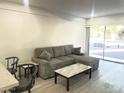 Living room with gray sectional and a marble-top coffee table at 353 E Thomas Rd # C104, Phoenix, AZ 85012