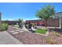 Landscaped backyard featuring a fire pit and seating area at 15820 S 177Th Dr, Goodyear, AZ 85338