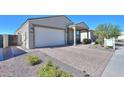 A charming one-story home with a two-car garage and landscaped yard at 15820 S 177Th Dr, Goodyear, AZ 85338