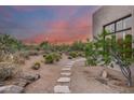 Landscaped backyard with stone pathway and desert plants at 8300 E Dixileta Dr # 253, Scottsdale, AZ 85266