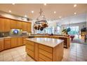 Large kitchen with island, wood cabinets, and tile flooring at 8300 E Dixileta Dr # 253, Scottsdale, AZ 85266
