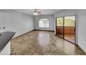 Bright living room featuring tile floors and sliding glass doors leading to a patio at 10030 W Indian School Rd # 257, Phoenix, AZ 85037