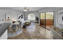 Living room with tiled floors, a sofa, and access to a patio at 10030 W Indian School Rd # 257, Phoenix, AZ 85037