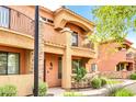 Front view of two-story home with balcony and landscaping at 21655 N 36Th Ave # 104, Glendale, AZ 85308