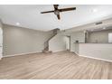 Open living room with wood-look floors and kitchen bar at 21655 N 36Th Ave # 104, Glendale, AZ 85308