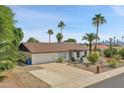 Single story home with a brown tile roof and white exterior at 2320 E Shangri La Rd, Phoenix, AZ 85028