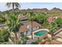 Aerial view of home with pool, mountain views, and palm trees at 2320 E Shangri La Rd, Phoenix, AZ 85028