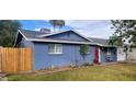 Charming blue house with a red door and wood fence at 1360 W 15Th St, Tempe, AZ 85281