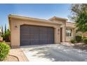 Tan house with brown garage door and a paved driveway at 120 E Camellia Way, San Tan Valley, AZ 85140