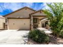 Single-story home with two-car garage and desert landscaping at 40486 W Sunland Dr, Maricopa, AZ 85138