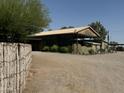 Main barn with covered area, rustic wooden fence at 642 E Cornman Rd, Coolidge, AZ 85128