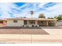 Ranch style home with carport and a well-manicured front yard at 6029 E Decatur St, Mesa, AZ 85205