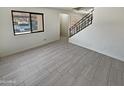 Living room with grey tile floors and staircase to upper level at 3511 E Baseline Rd # 1031, Phoenix, AZ 85042