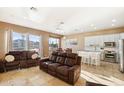 Open living room and kitchen with recessed lighting and tiled floors at 1438 W Coral Reef Dr, Gilbert, AZ 85233