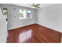 Bright bedroom with wood floors and a ceiling fan at 1750 E Mateo Cir # 103, Mesa, AZ 85204
