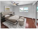 Spacious bedroom featuring a king-size bed and wood floors at 1750 E Mateo Cir # 103, Mesa, AZ 85204