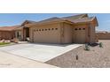 Tan house with two car garage and desert landscaping at 11225 E Ocaso Ave, Mesa, AZ 85212