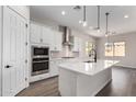 Bright white kitchen featuring an island, stainless steel appliances, and ample counter space at 16348 W Avenida Del Sol --, Surprise, AZ 85387