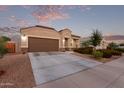 One-story home with brown garage door and landscaping at 285 S Espada Trl, Casa Grande, AZ 85194