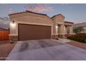 One-story home with brown garage door and landscaping at 285 S Espada Trl, Casa Grande, AZ 85194