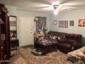 Living room with dark brown couches and a coffee table at 605 N Lesueur Cir, Mesa, AZ 85203