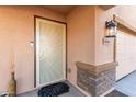 Front door with security screen and a stone accent at 8690 S 253Rd Ave, Buckeye, AZ 85326