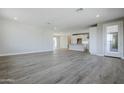 Open living area with wood-look floors and access to balcony at 2121 W Sonoran Desert Dr # 43, Phoenix, AZ 85085