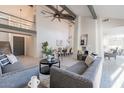 Spacious living room with high ceilings, exposed beams, and a modern aesthetic at 7344 E Keim Dr, Scottsdale, AZ 85250