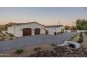 Luxury home showcasing a large driveway and three-car garage at 4723 E Desert Park Pl, Paradise Valley, AZ 85253