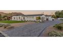 Elegant home with a curved driveway and mountain views at 4723 E Desert Park Pl, Paradise Valley, AZ 85253