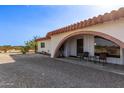 Arched entryway with covered patio and desert landscaping at 11801 S 193Rd Dr, Buckeye, AZ 85326