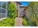 Charming courtyard entry with a fountain, lush greenery, and brick pavers at 8874 E Flathorn Dr, Scottsdale, AZ 85255