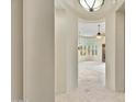Elegant hallway with tiled floors and built-in wooden shelving at 8874 E Flathorn Dr, Scottsdale, AZ 85255