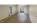 Living room with tiled floor and access to a balcony at 10828 N Biltmore Dr # 203, Phoenix, AZ 85029