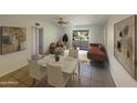 Combined dining and living room with a brown sofa at 10828 N Biltmore Dr # 203, Phoenix, AZ 85029
