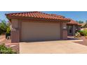 Attached garage with tan walls and terracotta roof at 15631 W Bethesda Ct, Surprise, AZ 85374