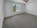 Bright bedroom with carpeted floors and ceiling fan at 142 W Latigo Cir, San Tan Valley, AZ 85143