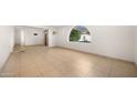Open living room with tile flooring and arched window at 7012 N 22Nd St, Phoenix, AZ 85020