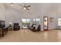 Relaxing living room featuring a leather couch and access to a patio at 2585 W Pinto Pl, Wickenburg, AZ 85390