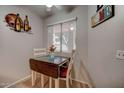 Cozy dining area with a drop-leaf table and chairs at 10978 W Coggins Dr, Sun City, AZ 85351