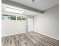 Spacious living area with a skylight and wood-look floors at 6116 N 12Th Pl # 7, Phoenix, AZ 85014