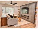 Bright living room features a modern fireplace and built-in shelving at 8308 E Holly St, Scottsdale, AZ 85257