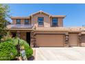 Two-story house with solar panels, three car garage, and landscaped front yard at 4506 W Maggie Dr, San Tan Valley, AZ 85144