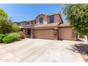 Two-story house with solar panels, three car garage, and landscaped front yard at 4506 W Maggie Dr, San Tan Valley, AZ 85144