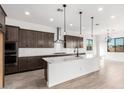 Open-concept kitchen and dining area with sliding glass doors leading to backyard at 21864 E Saddle E Ct, Queen Creek, AZ 85142