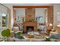 Living area with exposed brick fireplace and built-in shelving at 730 E Mckinley St, Phoenix, AZ 85006