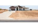 Newly built home with a two-car garage and spacious driveway at 5103 S 355Th Ave, Tonopah, AZ 85354