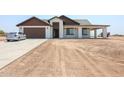 Newly built one-story home with a two-car garage and desert landscaping at 5103 S 355Th Ave, Tonopah, AZ 85354